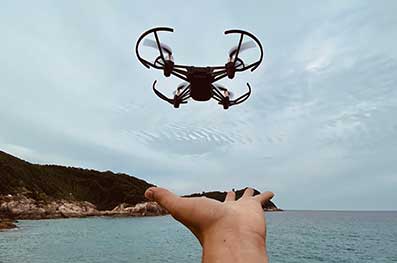 Drone surveying coastal region.