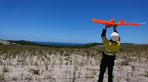 Professional drone and traditional survey aircraft comparing aerial surveying methods for construction, mining and infrastructure projects across Australia