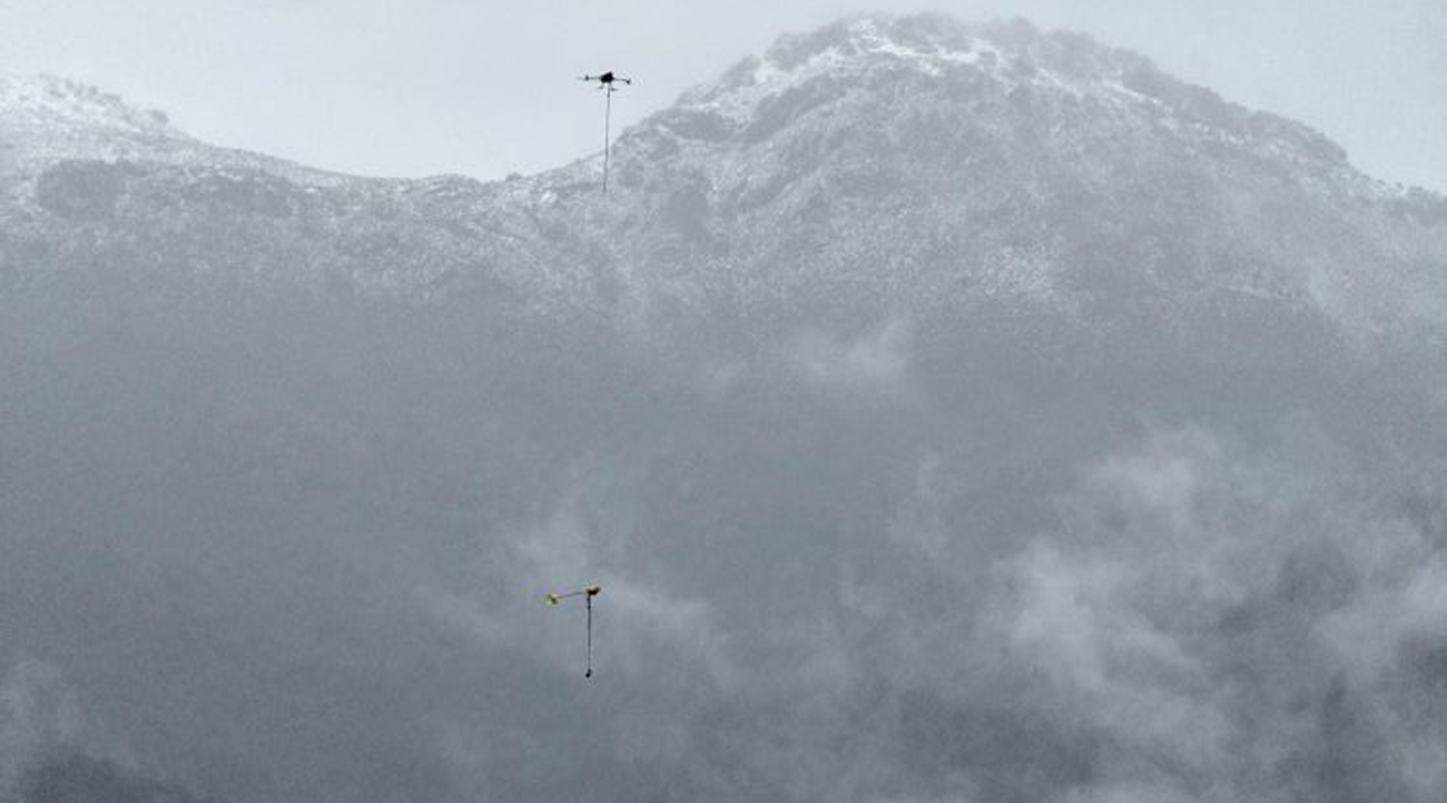 Flying Geophysics Assessments for Mine Sites: AUAV and Gap Geophysics Take UAVSAM Airborne 1 Gap Geophysics SAM receiver collecting airborne geophysical data over alpine terrain using UAVSAM technology